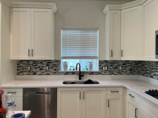 Mosaic tile backsplash in a white kitchen