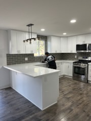 Subway tile backsplash and an island in a white kitchen