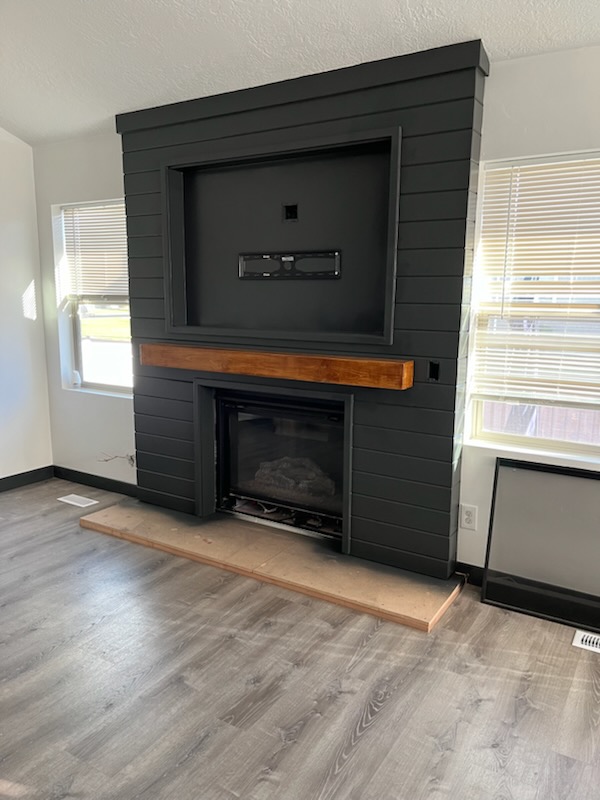 Dark fireplace surround under construction