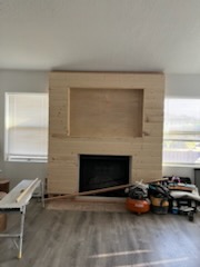 Fireplace surround part-clad in light timber