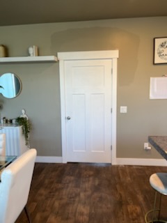 Dark flooring meeting a bathroom doorway