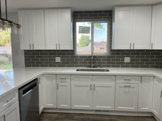 Grey subway tile backsplash framing a kitchen window