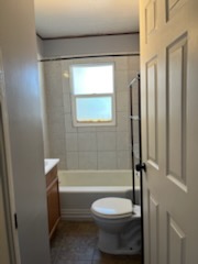 Small bathroom with a tub and a window above it