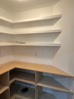 Built-in corner shelving with the painted shelves in place