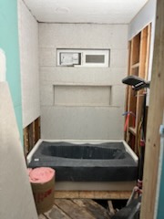 Bathroom with the tub set and cement board up, before tiling