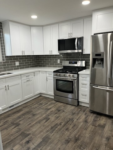 Grey subway tile backsplash in a finished kitchen