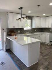 Finished kitchen with subway tile and pendant lighting