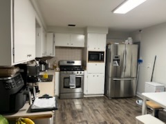 Plank flooring running under a run of kitchen appliances