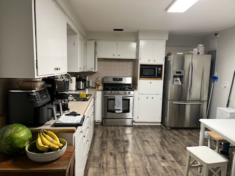 Wood-look plank flooring running through a kitchen