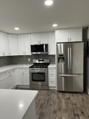 Finished kitchen with a grey tiled backsplash